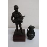 Resin model of a Royal Artillery soldier, posed holding as shell on plinth (18cm high), and a