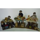 Set of three 20th C models; an artist with books paints and brushes, a baker with tarts and cakes on