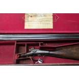 Cased Boss and Co 12 bore hammer gun with 30" barrels with under lever opening, serial number