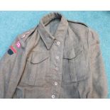 Three WWII period battle dress blouses with various war department markings, one by Rego Clothers