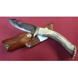 Silver Stag gutting knife with 4 inch blade, antler horn grip with brass cross piece and tan leather