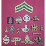 Selection of various British military cap badges, including Queen's Own Yeomanry, Royal Artillery,