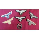 Six various embroidered German cloth Third Reich eagle above swastika military cloth badges and a