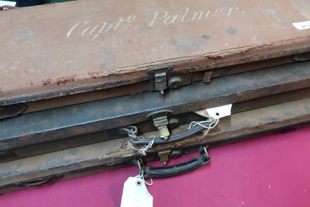 Three vintage canvas and leather bound gun cases, one with Jeffrey and Co trade label, another for