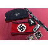 Large collection of reproduction German WW2 badges, arm bands, side caps , belts , medals etc