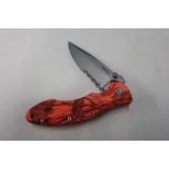Boxed as new Whitby Knives folding knife with floro. camo handle