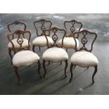 Set of six late 19th C walnut balloon back dining chairs with carved and pierced splat serpentine