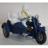 Michelin man with passenger on blue painted motorbike and sidecar