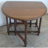 1930s oak gateleg table, with two D shaped fall leaves on barley twist supports joined by stretchers
