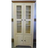 Cream finished display cabinet with waxed oak cornice, three adjustable shelves (90cm x 195cm x