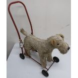 Vintage Pedigree Soft Toys plush covered push along model of an Irish Terrier on red frame with