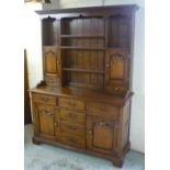 Georgian style oak dresser with three shelves flanked by cupboards and drawers, base with six