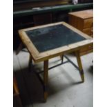 Rustic pine table, the square top inset with enamel panel