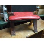 20th C camel saddle with upholstered seat and carved pommels