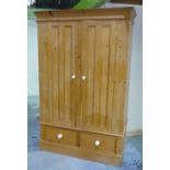 Pine wardrobe enclosed by two panelled doors over two drawers, with molded cornice (194cm x 63cm x