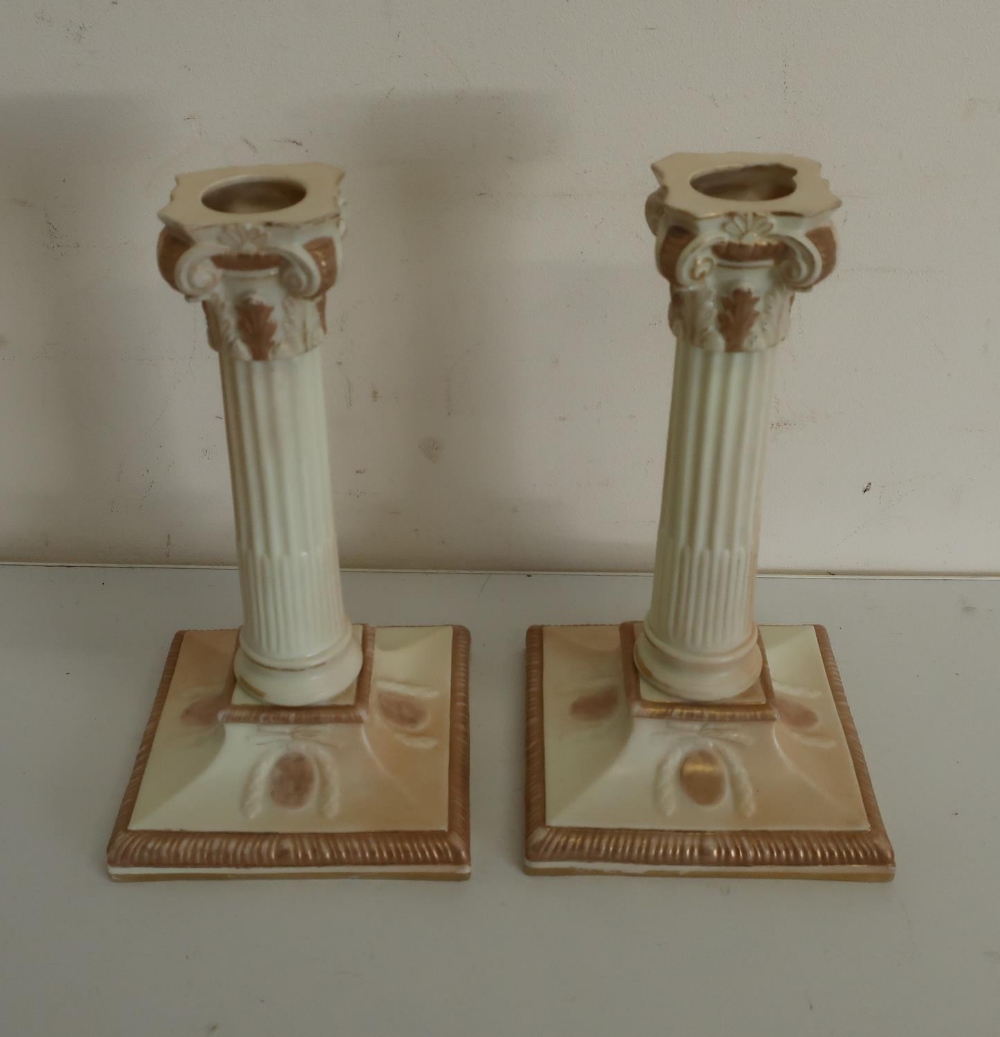 Pair of Victorian Royal Worcester candlesticks, with stop fluted columns and acanthus scroll