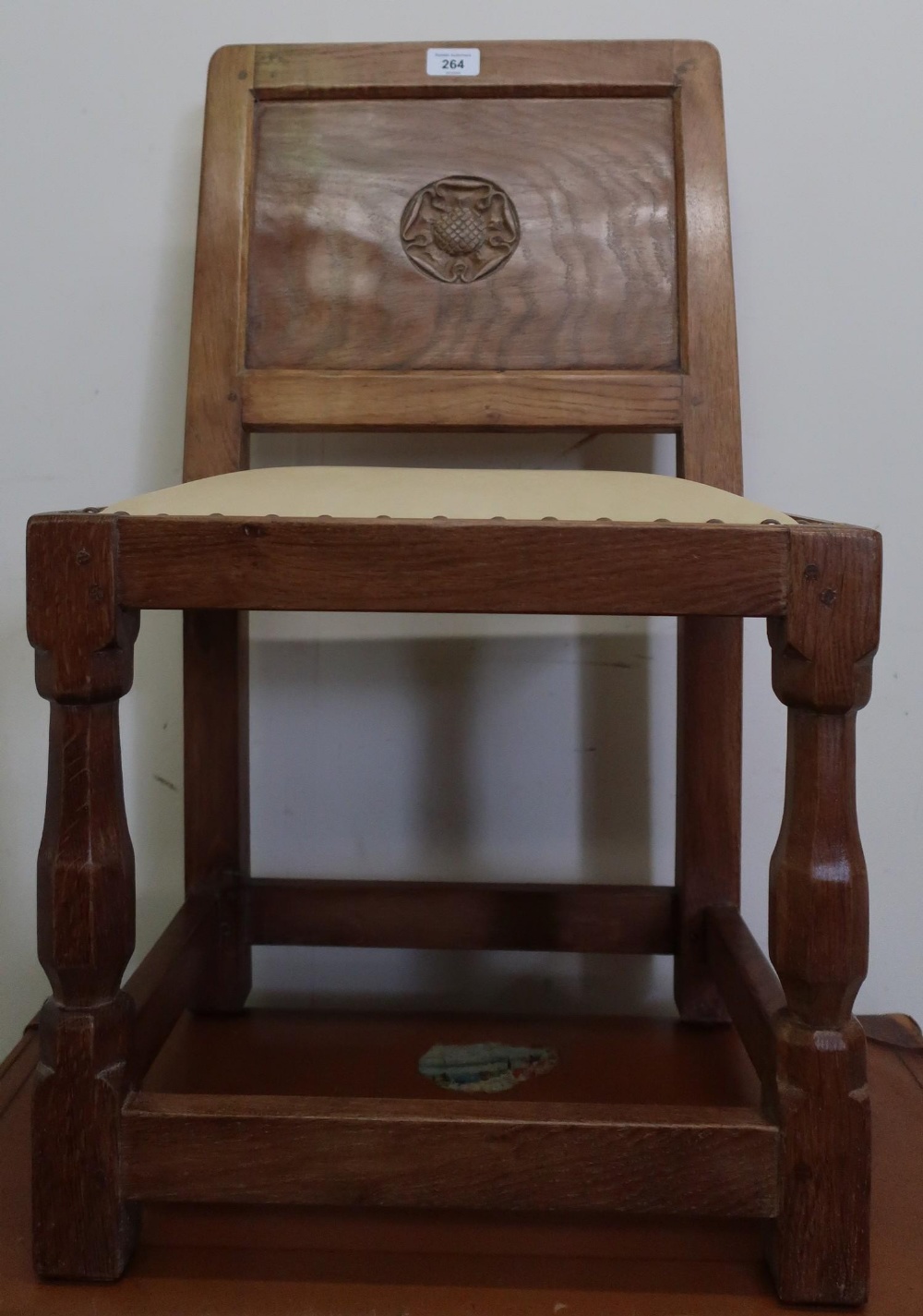Yorkshire oak childs chair, panel back carved with a Yorkshire rose, brass nail upholstered seat, on