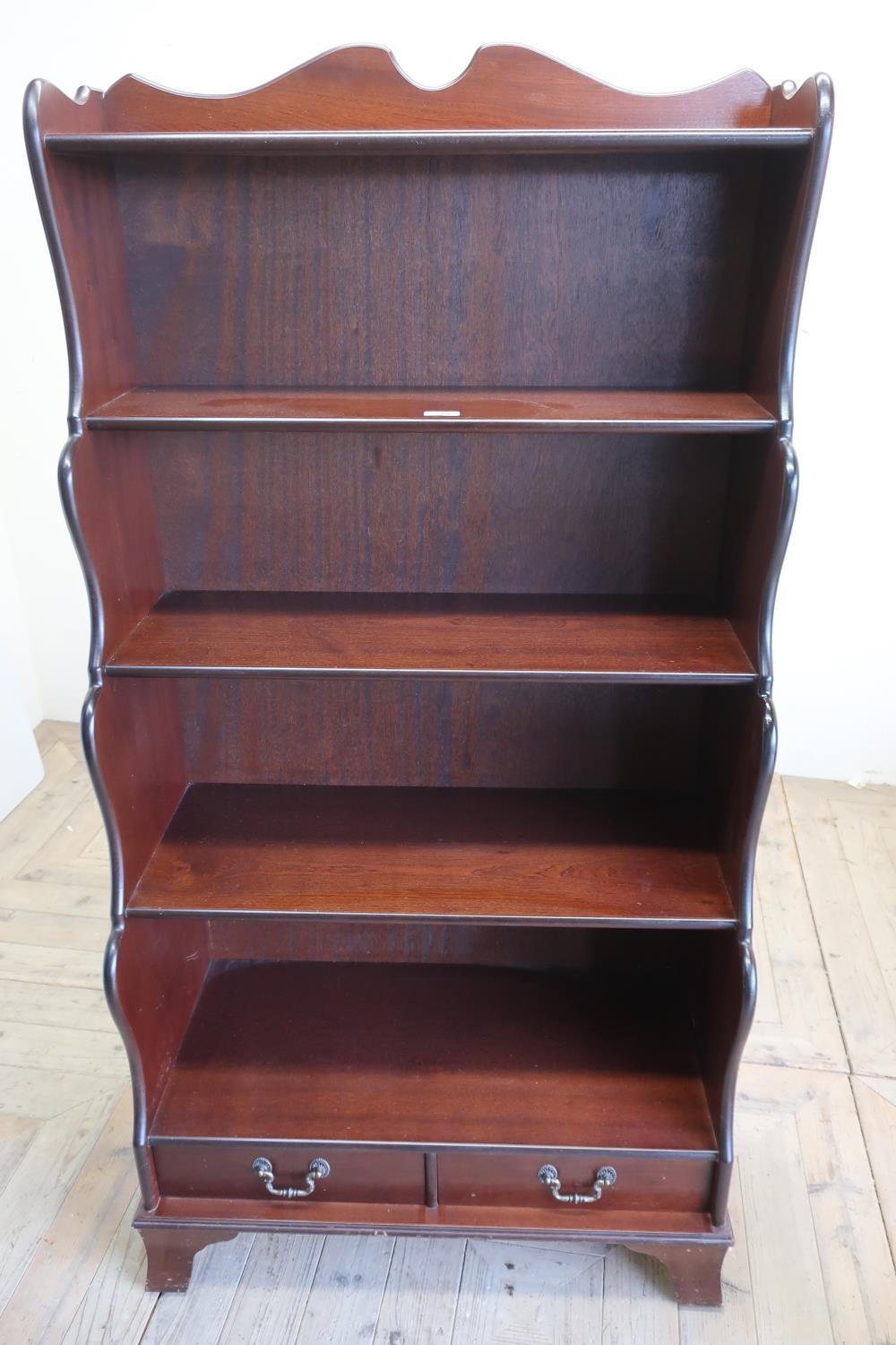 Strongbow mahogany five tier waterfall bookcase with two drawers on bracket feet (77cm x 152cm x