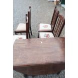 20th C oak drop-leaf gate-leg dining table on barley twist legs, and a set of four similar rail back