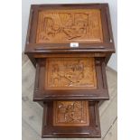 Nest of three eastern hardwood tables with carved tops