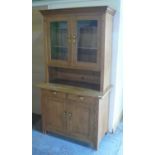 Natural pine dresser, shaped cornice two shelves enclosed by glazed doors over two drawers and two