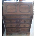19th C oak bureau with panelled fall front revealing fitted interior above three drawers, on bracket