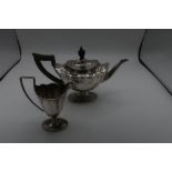 Edwardian hallmarked silver teapot, shaped oval body with ebonised handle and finial on tapered oval