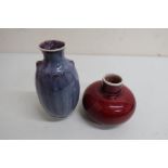 High fired red glaze squat mallet shaped vase, and a similar turquoise glaze ovoid vase initialed RW