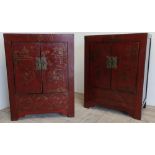 Pair of Shan Shi elm red lacquered two door side cabinets, decorated in gilt with fighting figures