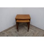 Legante nest of two serpentine teak occasional tables on square tapered supports (37cm x 45cm x