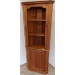 Modern pine floor standing corner unit with two tier open top above panelled cupboard door (width