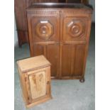 20th C oak tallboy, two carved and panelled doors enclosing partly fitted interior, and a