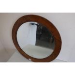 Circular beveled edge wall mirror in golden oak frame (diameter 60cm) and a mahogany framed oval