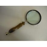 Large magnifying glass, with circular lens in chromed surround on turned wooden handle (length 58cm)