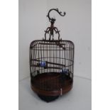 Chinese carved wood and wirework cylindrical birdcage, with three perches, on metal dragon hanging