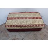 Rectangular footstool in red and striped fabric on bun feet (115cm x 65cm x 35cm)