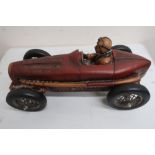 Cast resin model of a vintage single seater racing car with red body on black spoked wheels (L50cm)