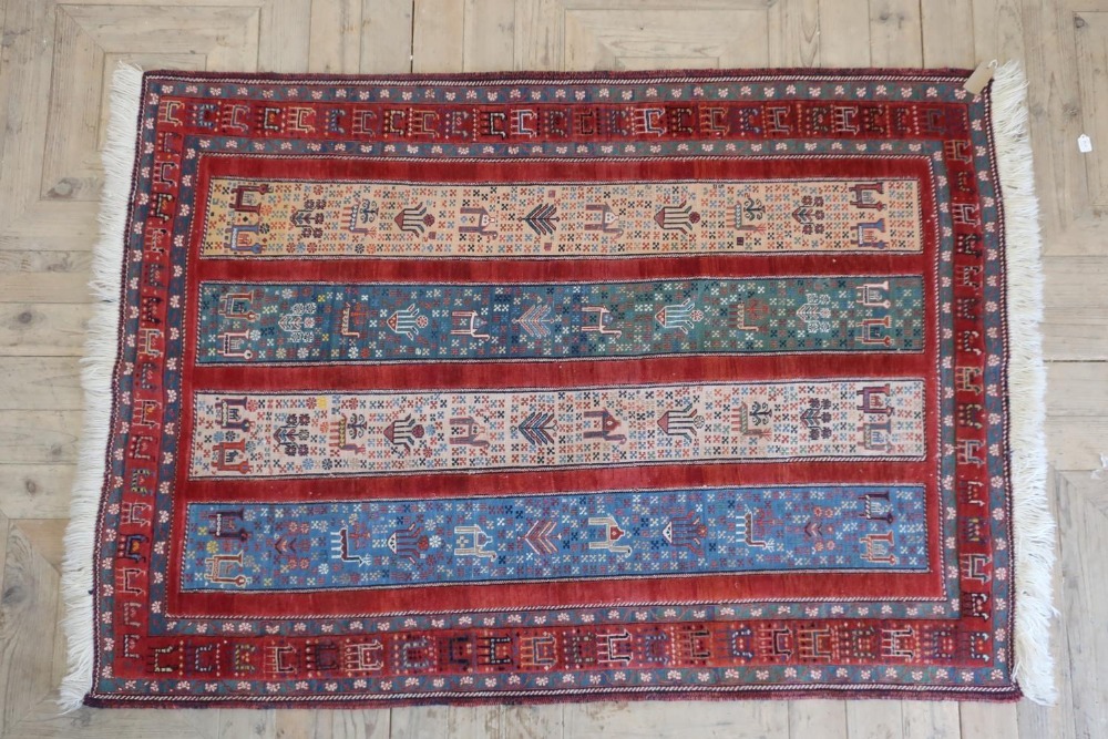Caucasian multicoloured rug, the four stripe field filled with animals and foliage within a