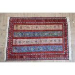 Caucasian multicoloured rug, the four stripe field filled with animals and foliage within a