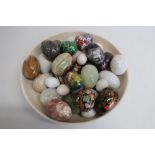 Collection of onyx and other polished agate and painted eggs in a shallow bowl (30)