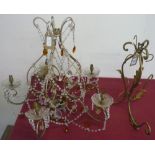 Wrought metal chandelier with five scrolling branches hung with clear prismatic drops and amber