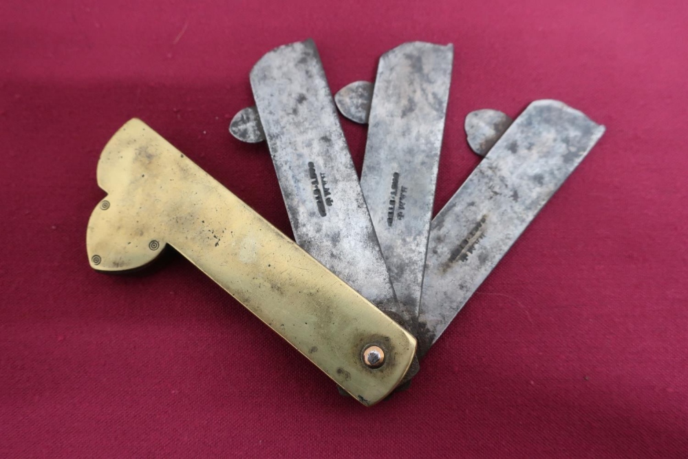 Early 20th C brass Fleam, the three steel blades each stamped Ham Cast Steel (length 9.5cm)