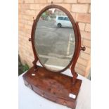 19th C mahogany oval dressing table mirror with two short and one long drawers, on bracket feet (