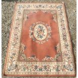 20th C Belgian traditional pattern pink ground rug with central floral medallion with garland