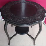 Late Victorian ebonised two tier occasional table with carved border to the top (diameter 75cm)