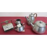 English hammered pewter four piece tea service stamped 0993, the hot water and teapot with wicker