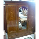 Edwardian mahogany inlaid wardrobe with stepped cornice above central bevelled edge mirrored