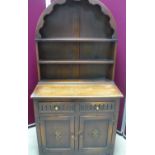Small oak dresser with two twin shelved back above two drawers, and two panelled and carved cupboard