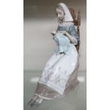 Large Lladro porcelain model of a young girl sewing in a chair (H30cm)