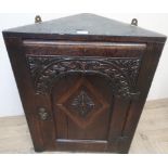 Antique oak corner cupboard, with carved arched door inlaid with a lozenge panel (58cm x 78cm x